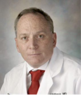 Headshot of Dr. McManus in white coat and red tie